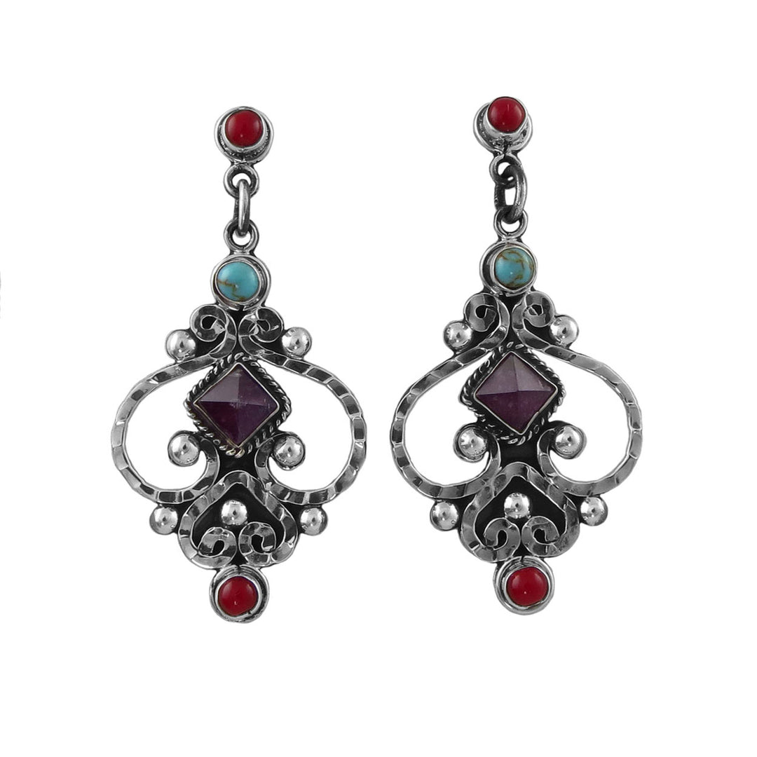 A pair of ornate sterling 925 silver dangle earrings featuring a central dark purple square amethyst gemstone, accented with a small turquoise stone, a round red coral gemstone, and textured silver filigree on a plain white background.