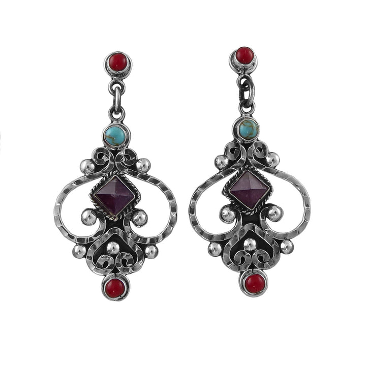 A pair of ornate sterling 925 silver dangle earrings featuring a central dark purple square amethyst gemstone, accented with a small turquoise stone, a round red coral gemstone, and textured silver filigree on a plain white background.