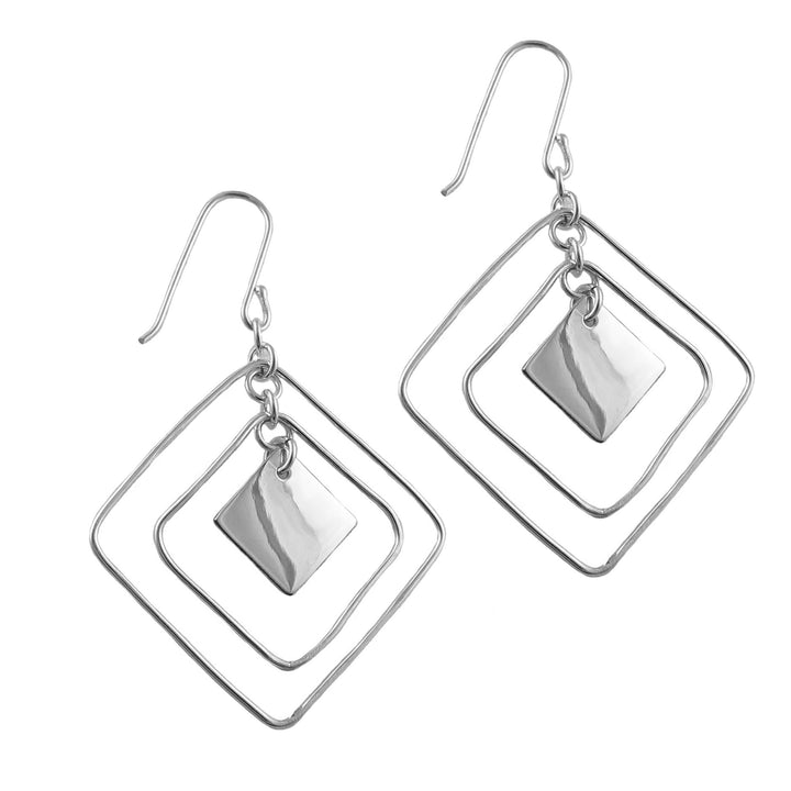 A pair of silver dangle earrings with a geometric design, featuring nested square wire frames and a small polished square charm, shown on a plain white background.