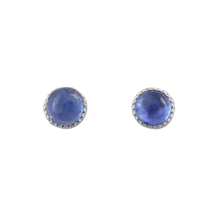 A pair of round stud earrings featuring smooth blue tanzanite cabochon gemstones set in 925 silver bezel settings with a beaded border, shown on a plain white background.