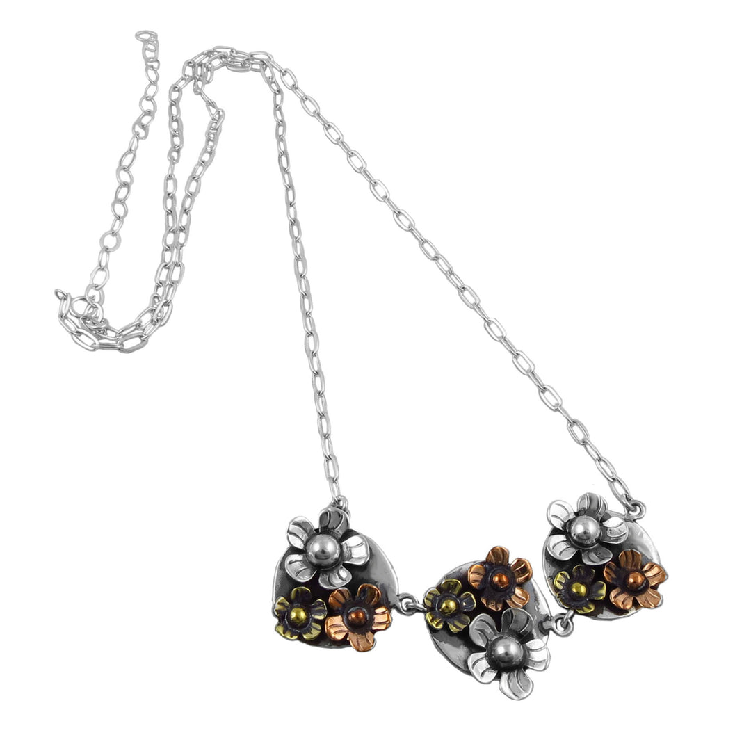 Necklace with three flower-shaped pendants on a white background