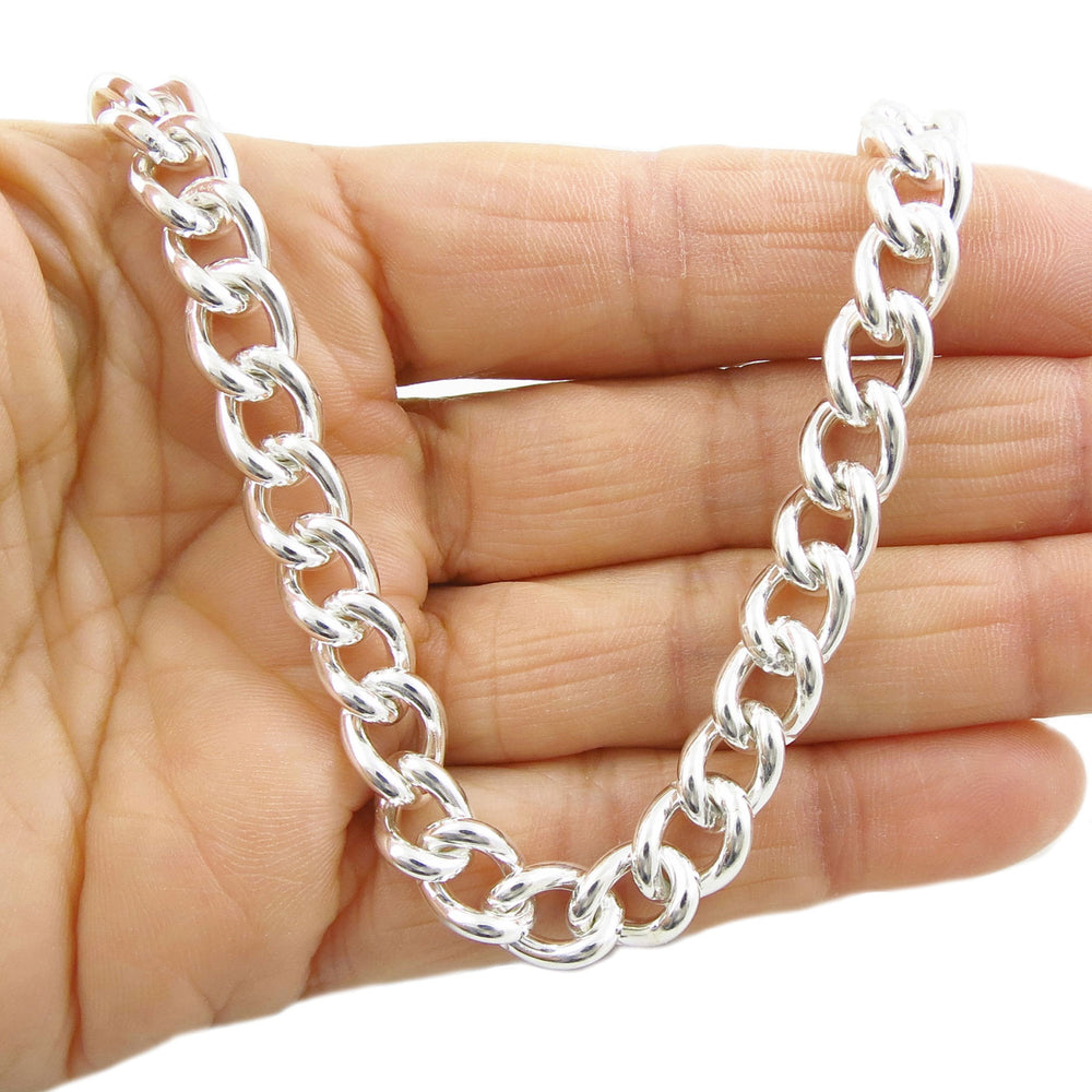 A heavy 925 sterling silver solid curb chain necklace displayed on a hand.
