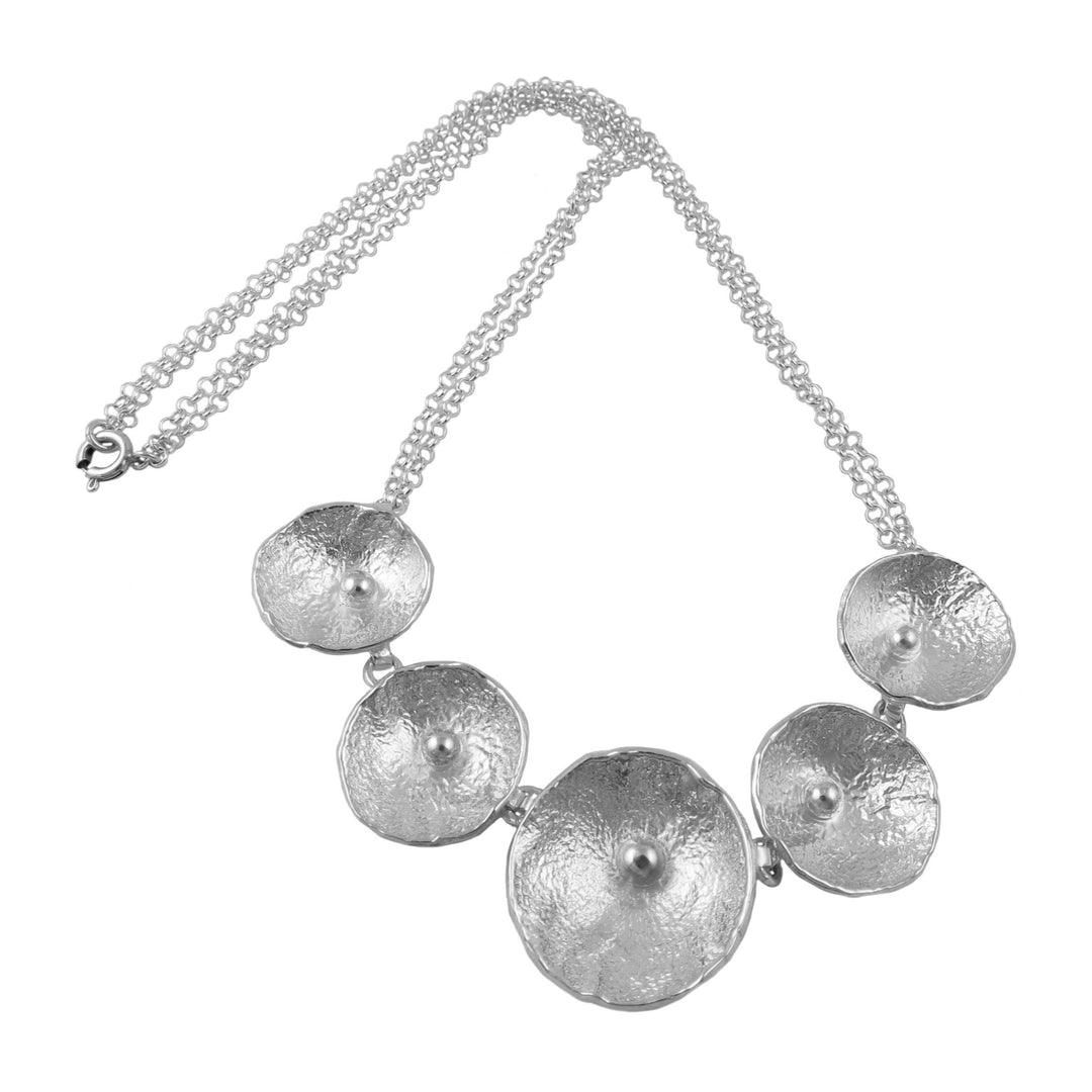 Silver chain necklace with round poppy flowers on a white background