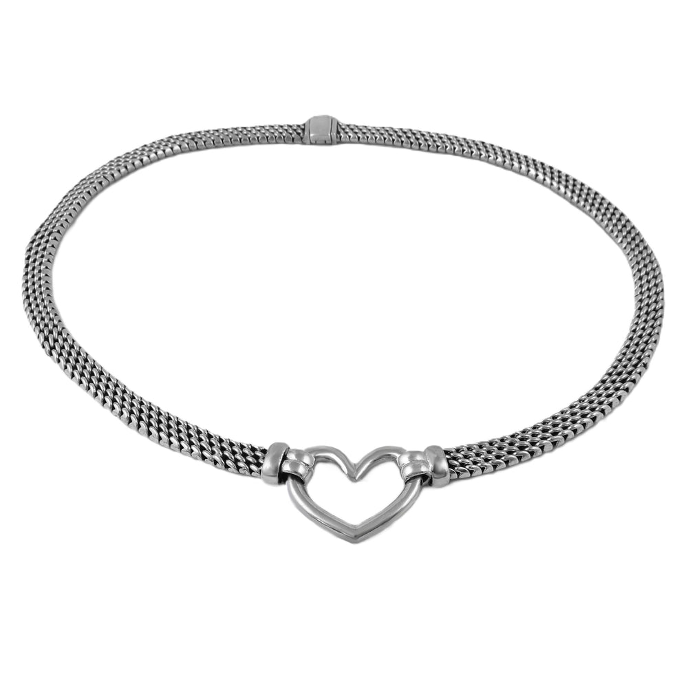 Silver chain necklace with a heart-shaped pendant on a white background