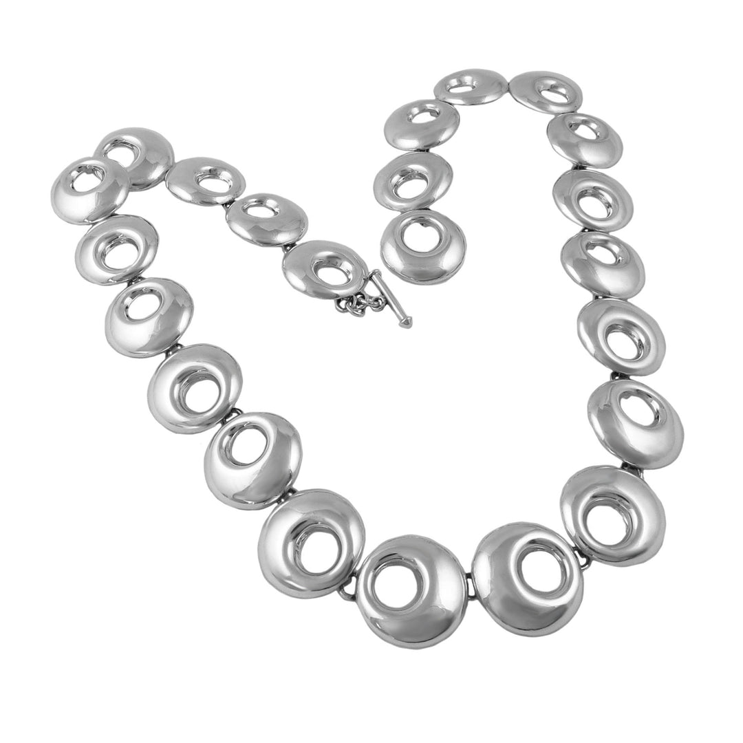 Silver necklace with circular links on a white background
