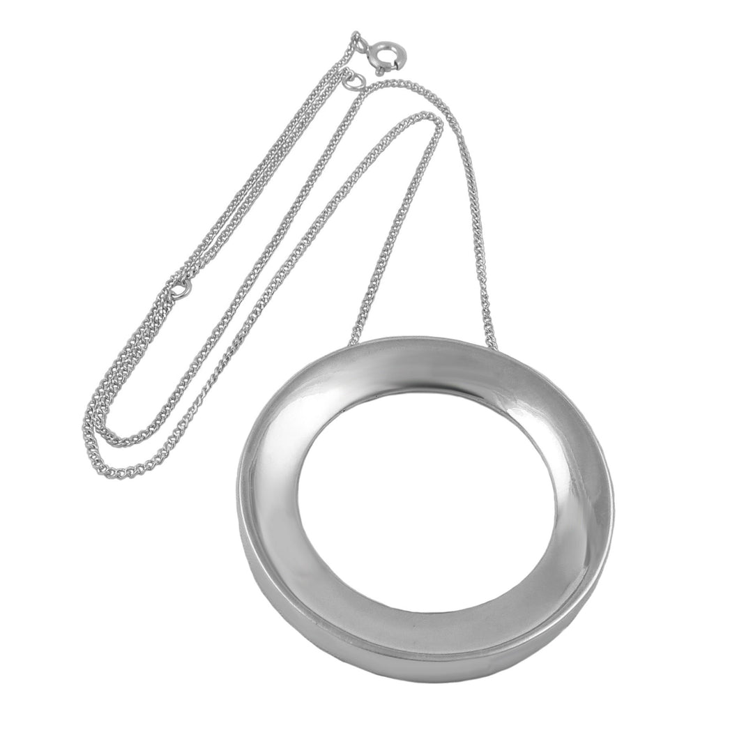 Silver circular pendant on a chain against a white background