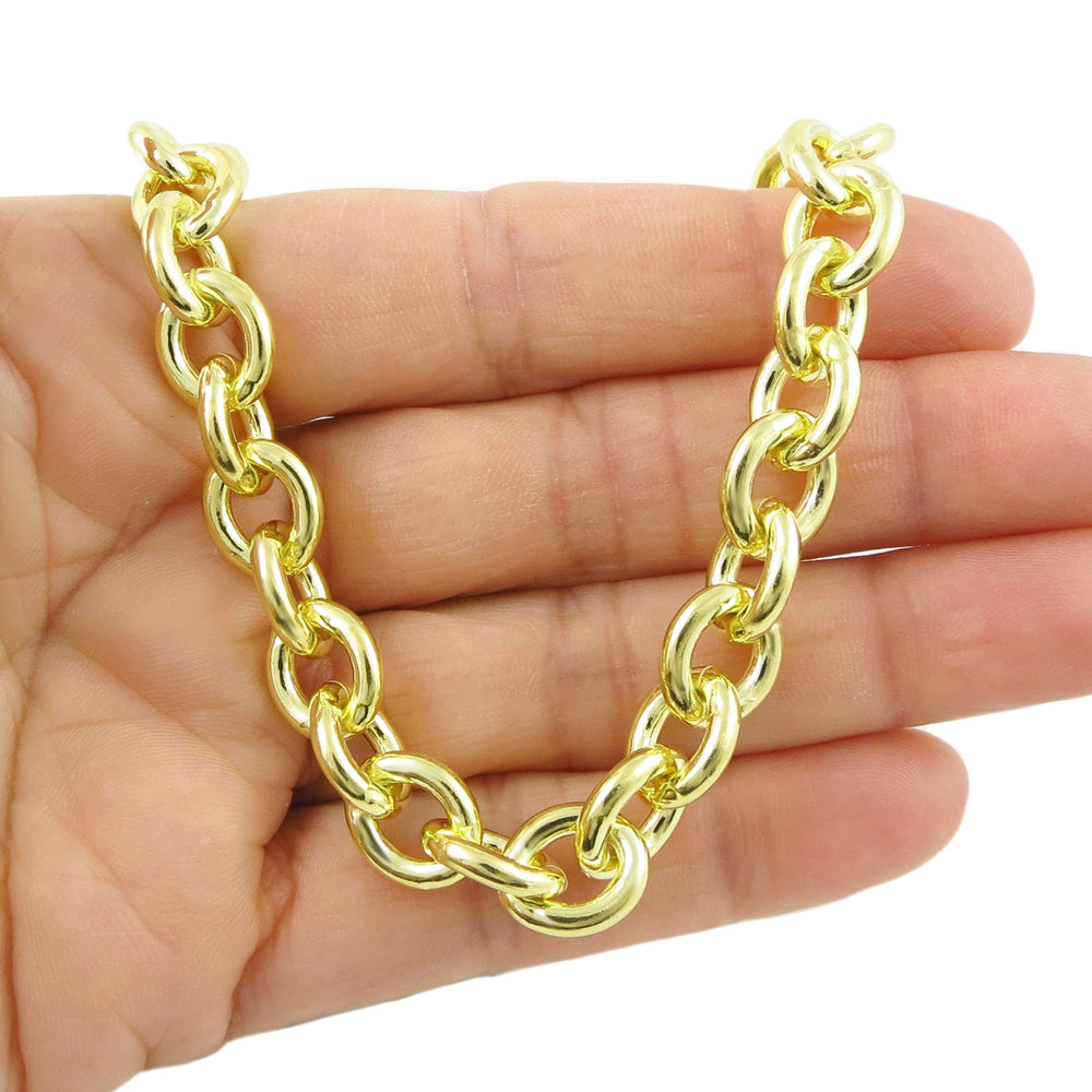 Yellow 14ct gold chain necklace held in a hand against a white background