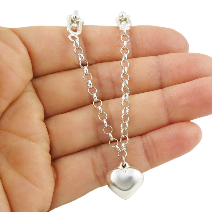 Taxco sterling 925 Silver chain necklace with a heart pendant held in a hand against a white background