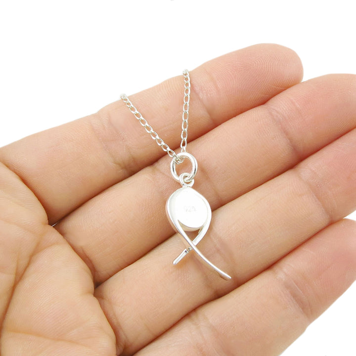 925 silver necklace with a unique peridot gemstone pendant held between fingers on a white background