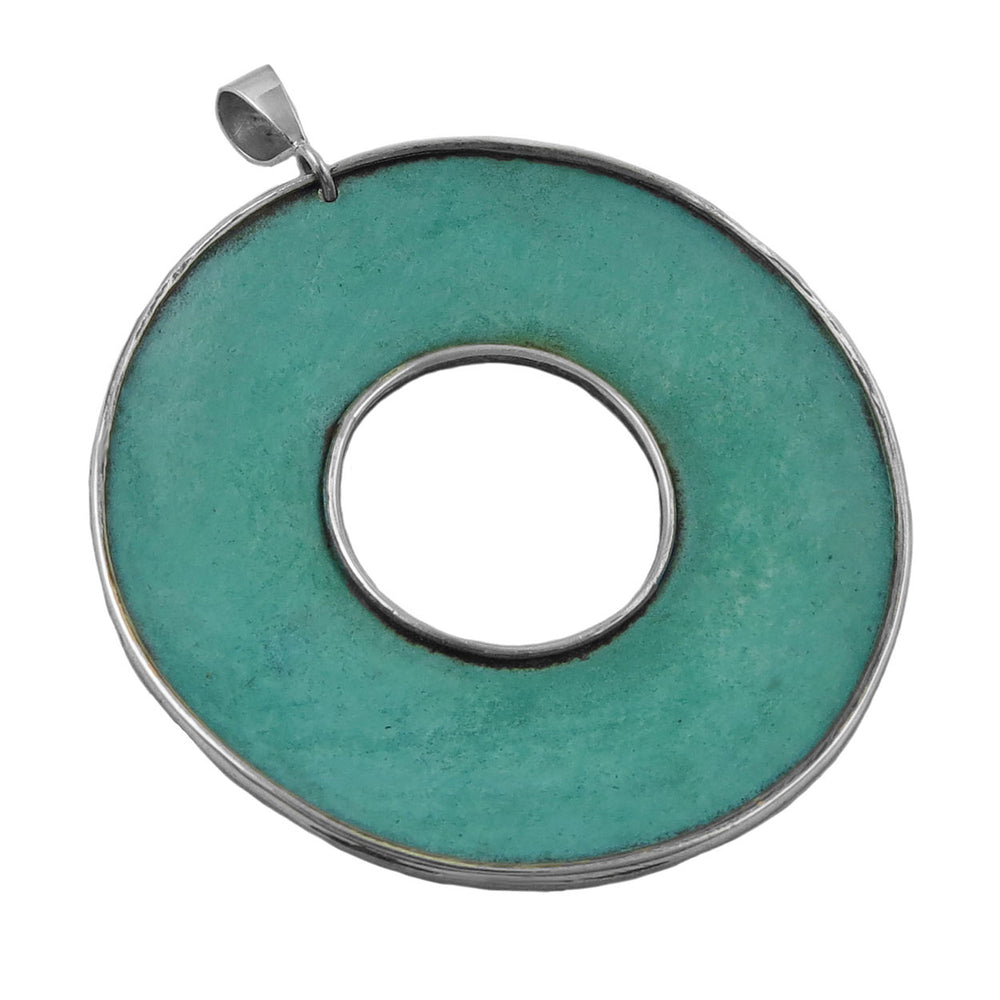 Green opper patina pendant with silver frame on a white background