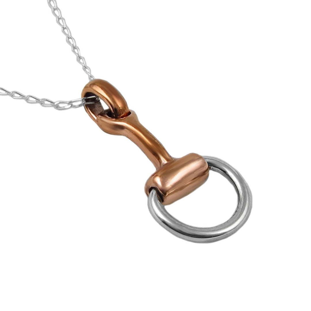 Copper and silver horse bit pendant on a chain against a white background