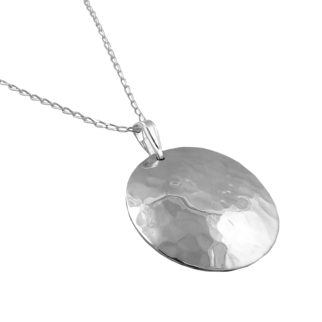 Taxco 925 sterling silver pendant and curb chain necklace on a white background