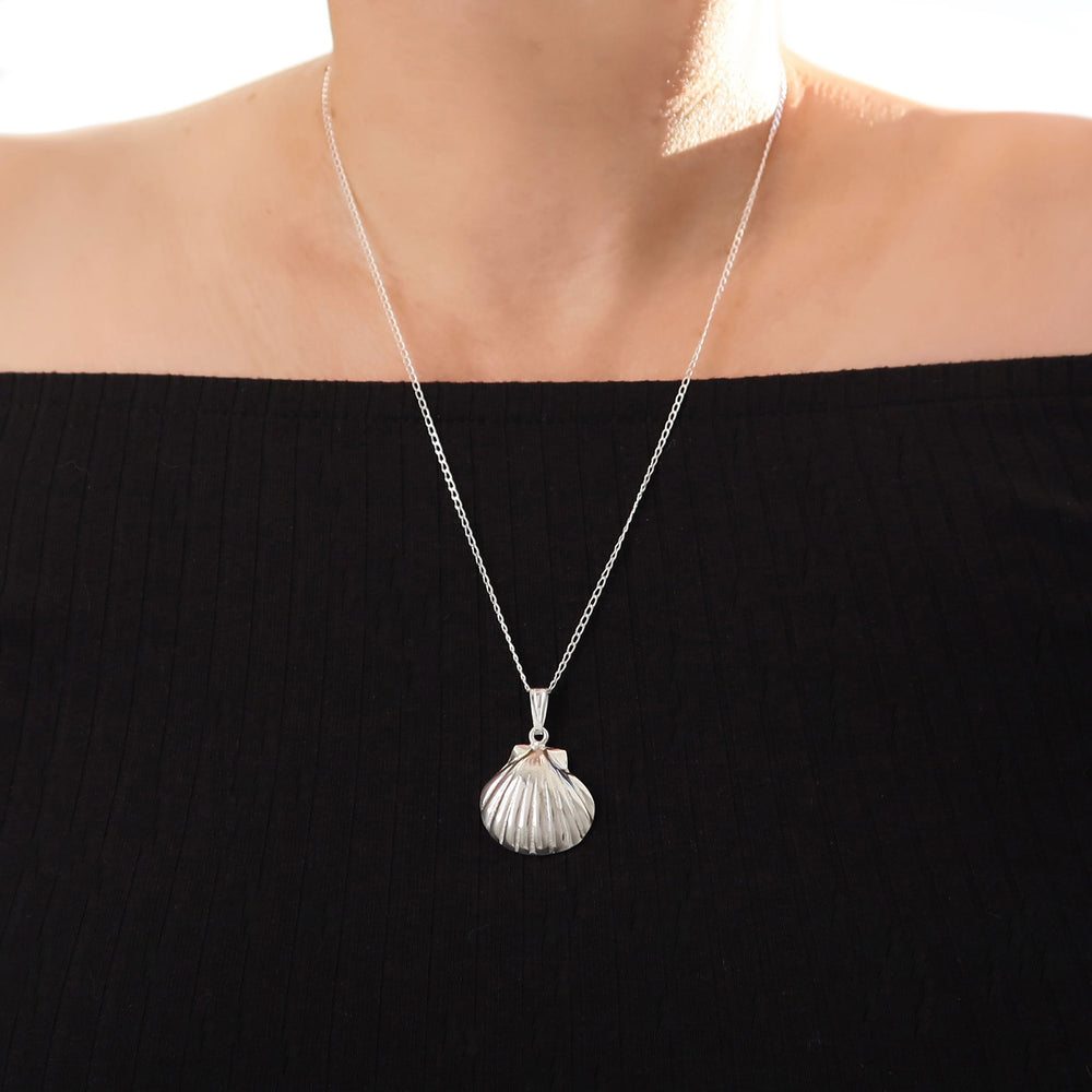 Llong 925 sterling silver necklace with a seashell conch pendant worn by a woman in an off the shoulder black blouse