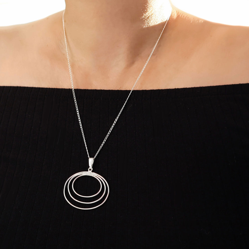 Sterling 925 silver pendant and chain statement necklace worn by a woman in a black off the shoulder top
