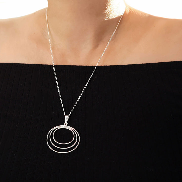 Sterling 925 silver pendant and chain statement necklace worn by a woman in a black off the shoulder top