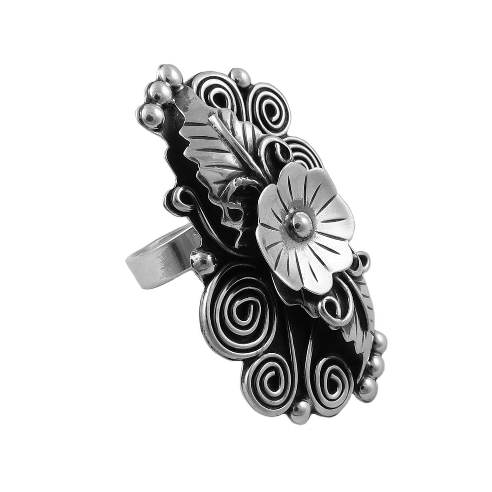 A large handmade sterling 925 silver Taxco cocktail ring with a large floral motif, featuring curling vines and berries.