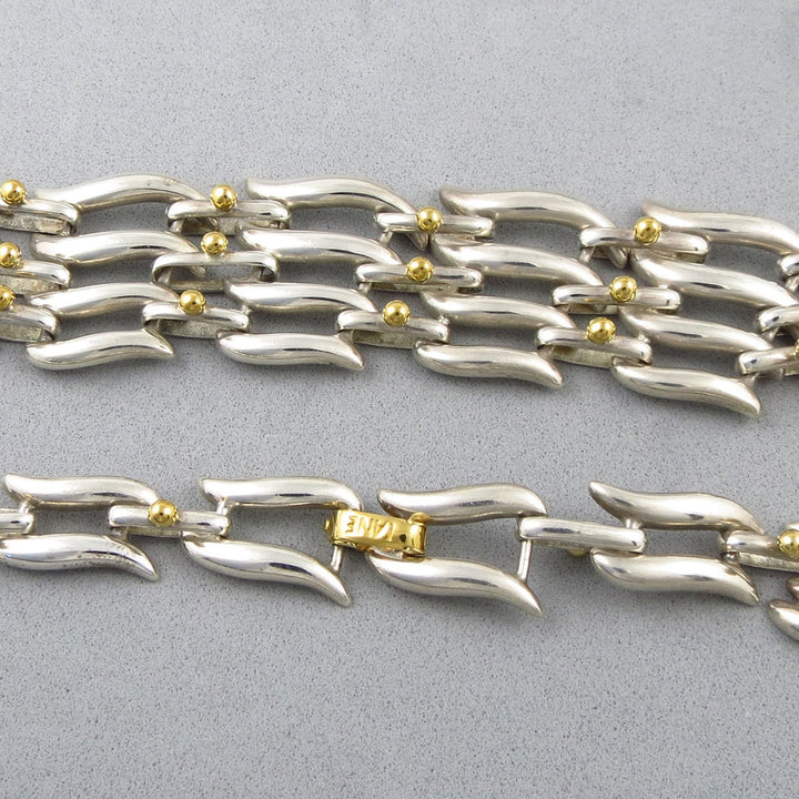 Sterling 925 Silver and gold Tane Mexico chain necklace with a roll-over clasp on a gray background