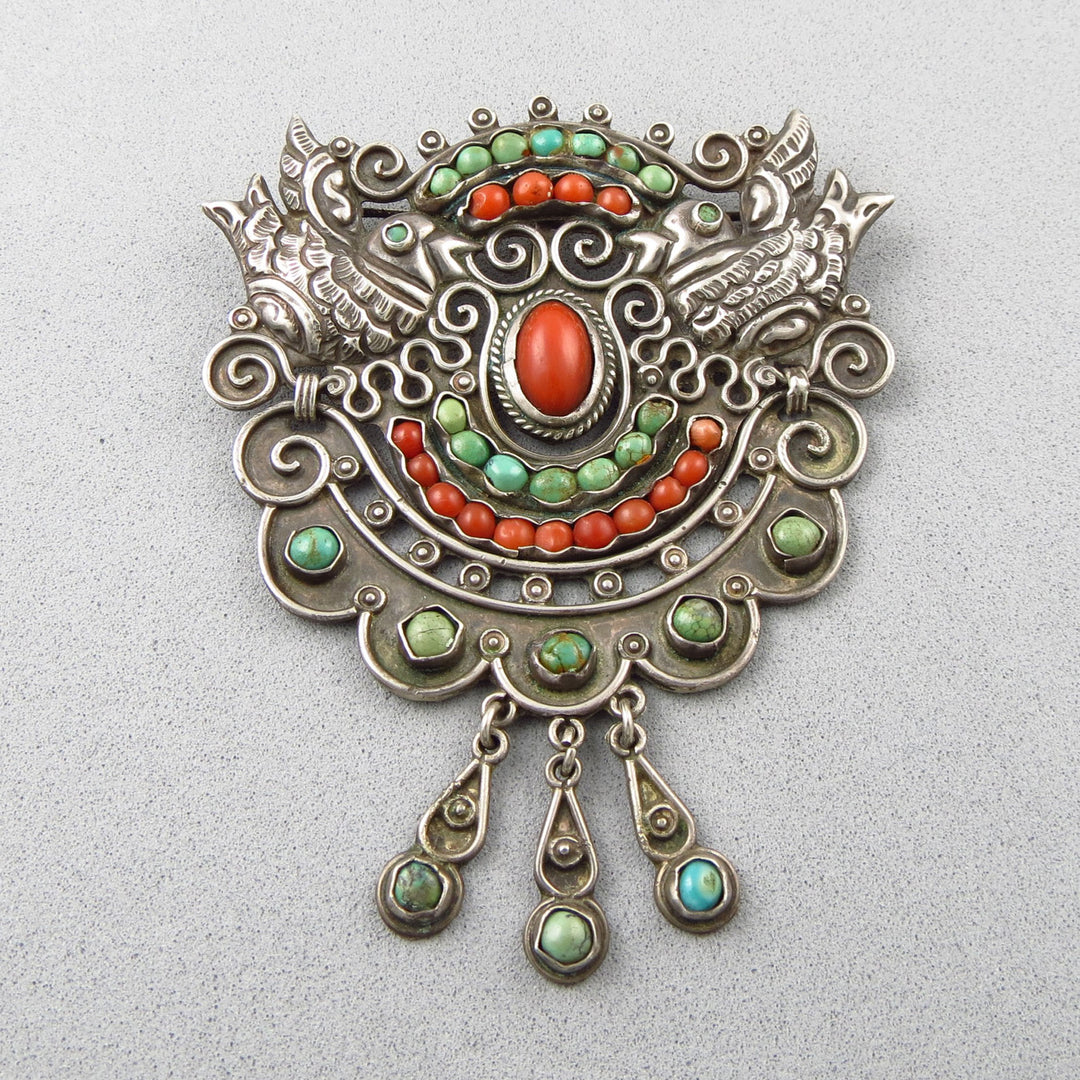 Large early MATL Mexican 925 silver brooch with colorful coral and turquoise stones on a light gray background