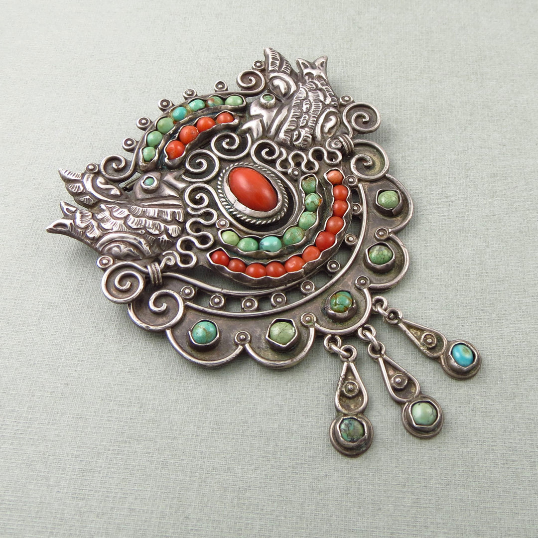 Vintage Ricardo Salas for MATL Mexican 925 silver, coral & turquoise gemstone brooch on a light gray background