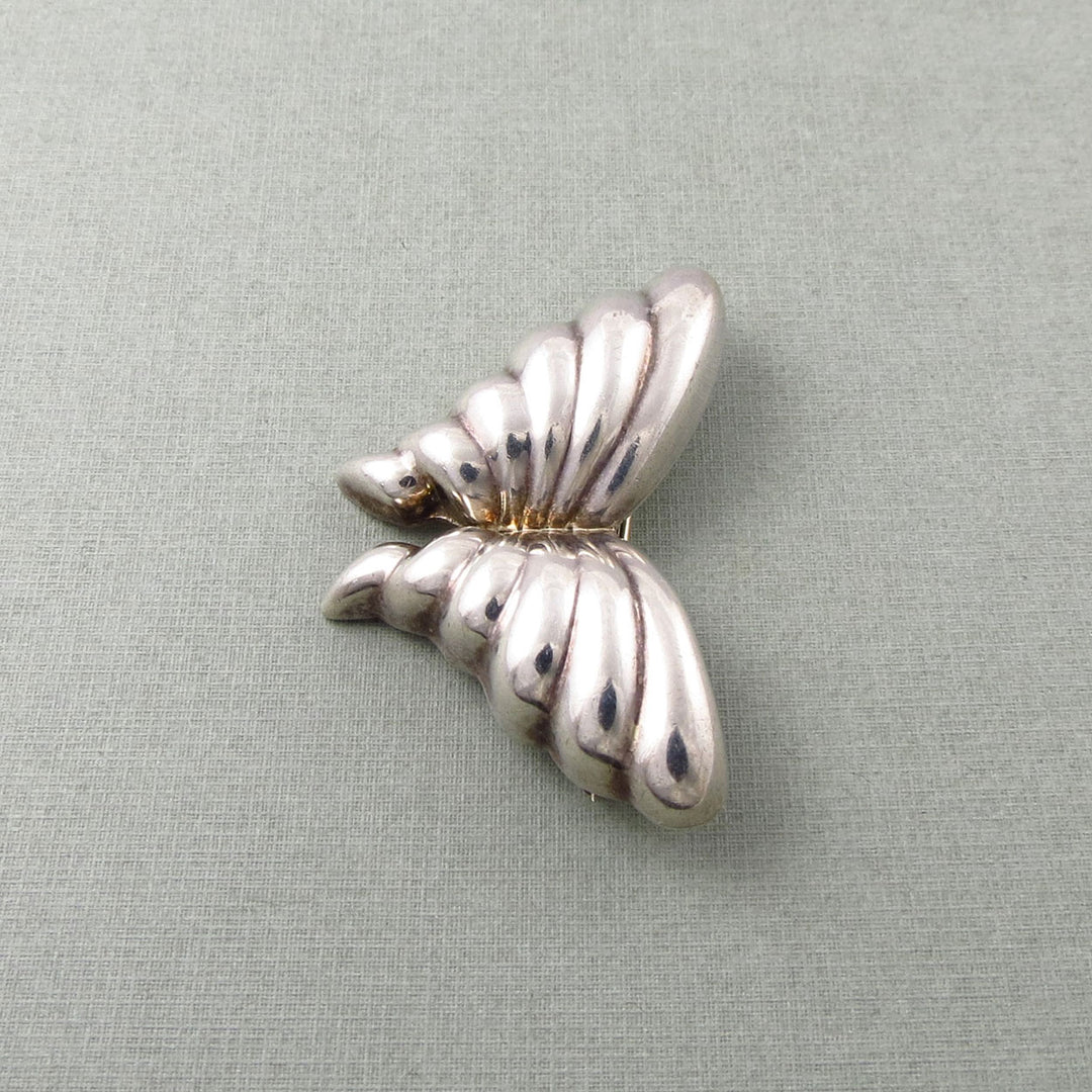 Mexico sterling Silver Tiffany & co vintage butterfly-shaped brooch on a light grey background