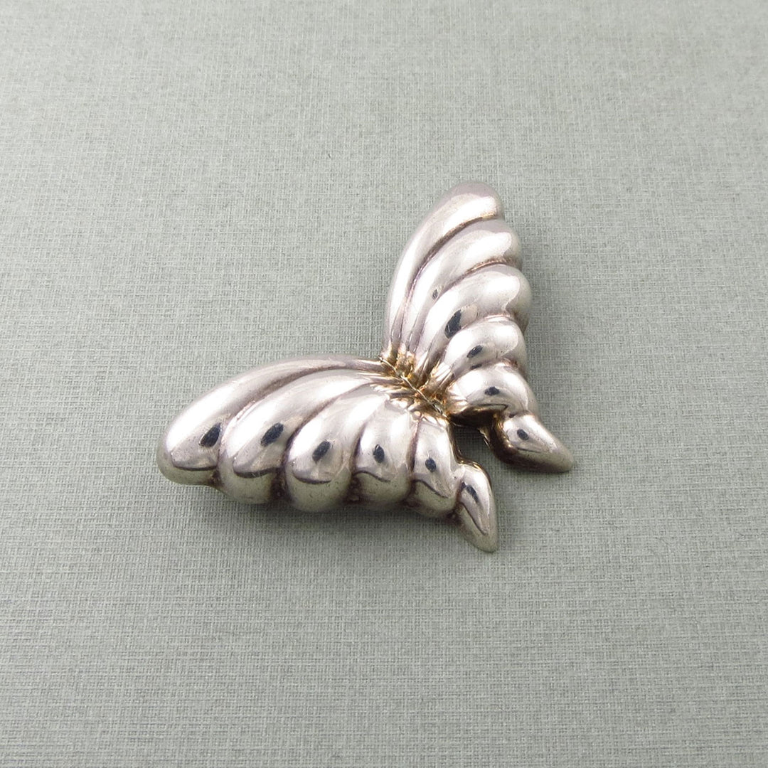 Tiffany & co vintage sterling 925 Silver butterfly-shaped brooch on a light gray background