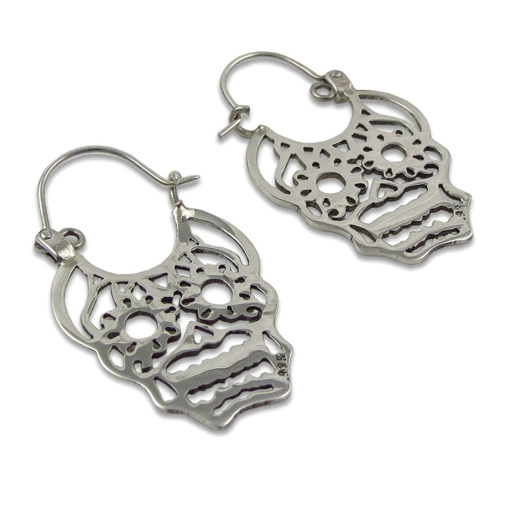 Papel picado design silver day of the dead skull earrings on a white background. 