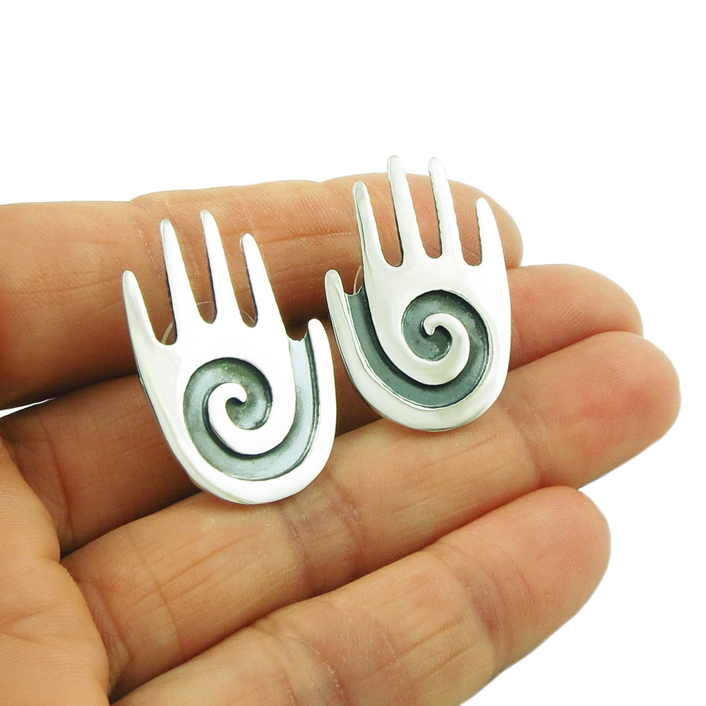 Sterling silver stud earrings in the shape of open palm hands. 