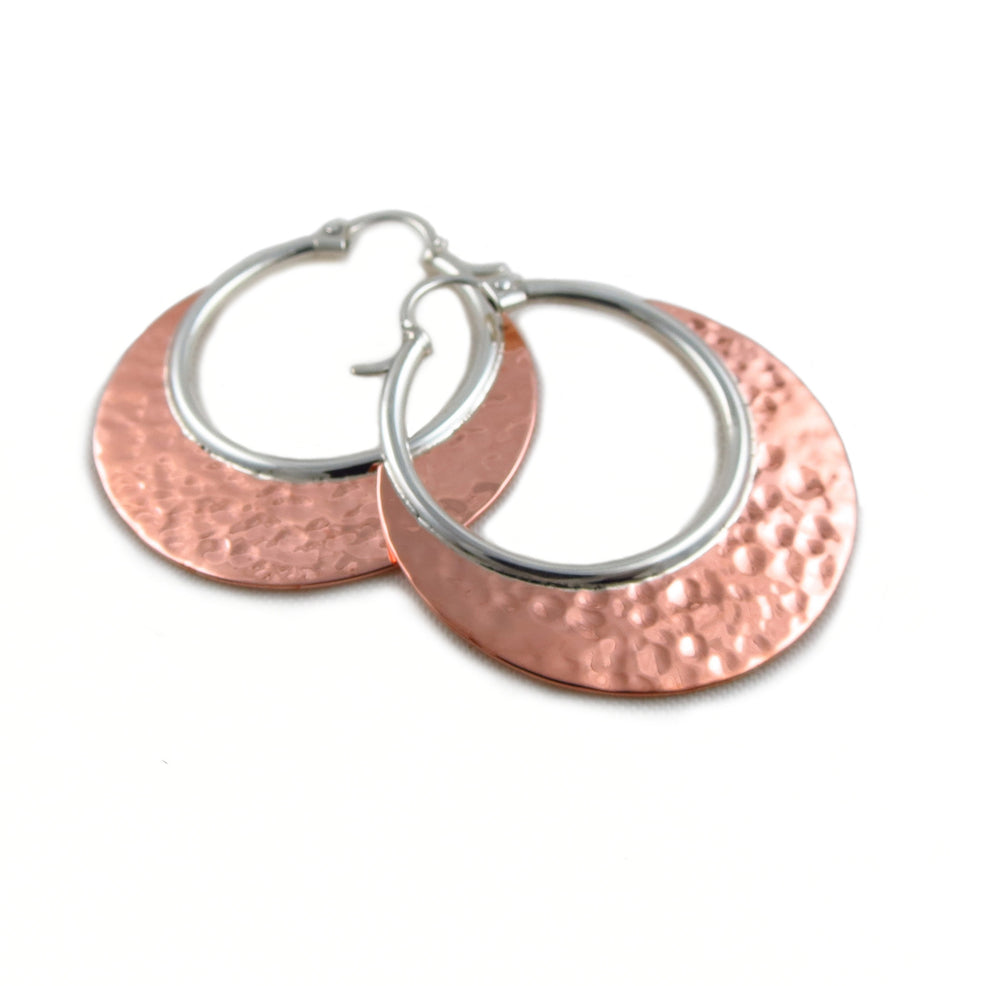 A pair of two-tone creole large unique hoop earrings for women made of hammered copper and 925 sterling silver.