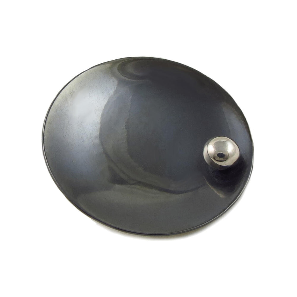 A sterling silver disc pendant with a blackened niello design and a central ball bead.